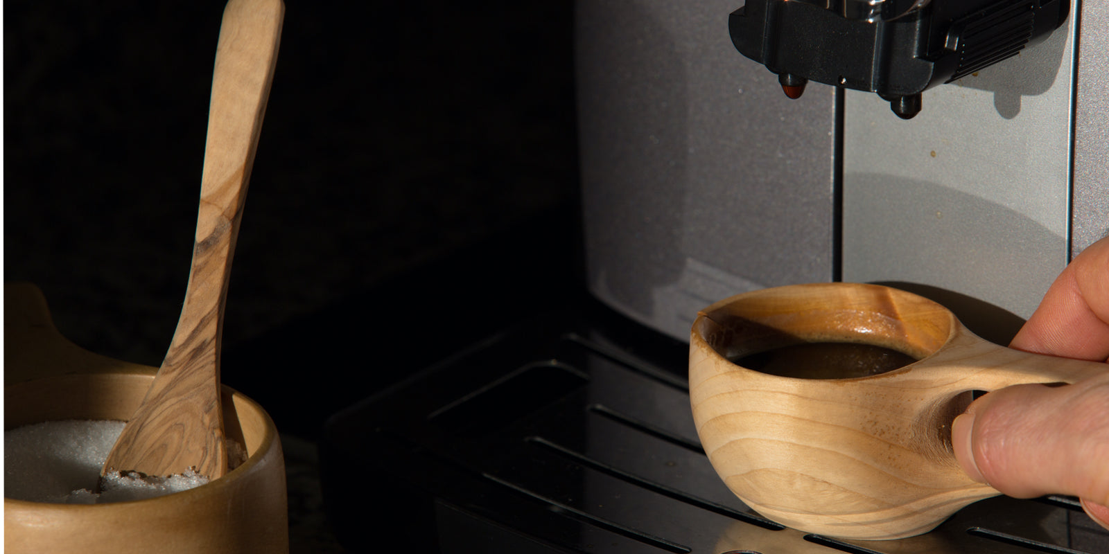 
          
            Image of espresso machine dispensing coffee into bamboo cup
          
        