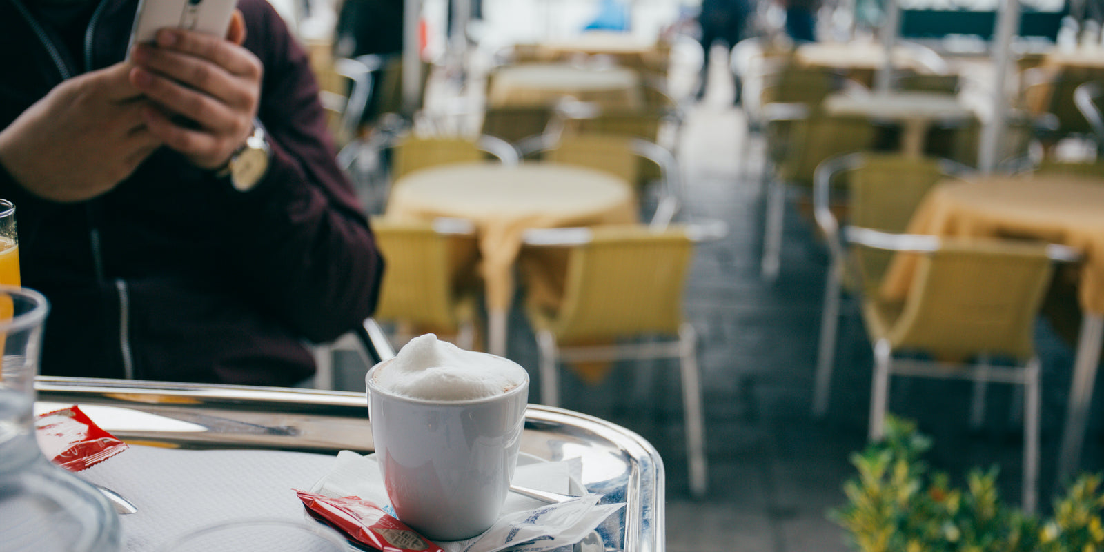 
          
            Tourist enjoying a cappuccino at a café in Italy
          
        