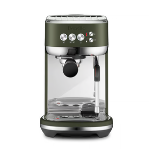 Breville Bambino Plus espresso machine in olive green with portafilter and steam wand, ready for brewing coffee.
