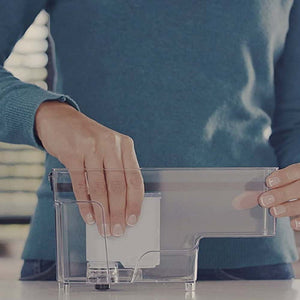 Man Placing Saeco Philips AquaClean Filter in Water Tank of Espresso Machine